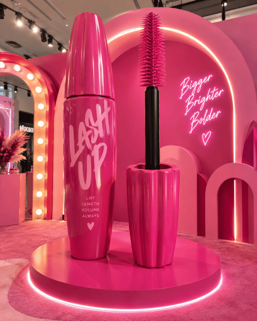 Oversized pink mascara tube and wand display