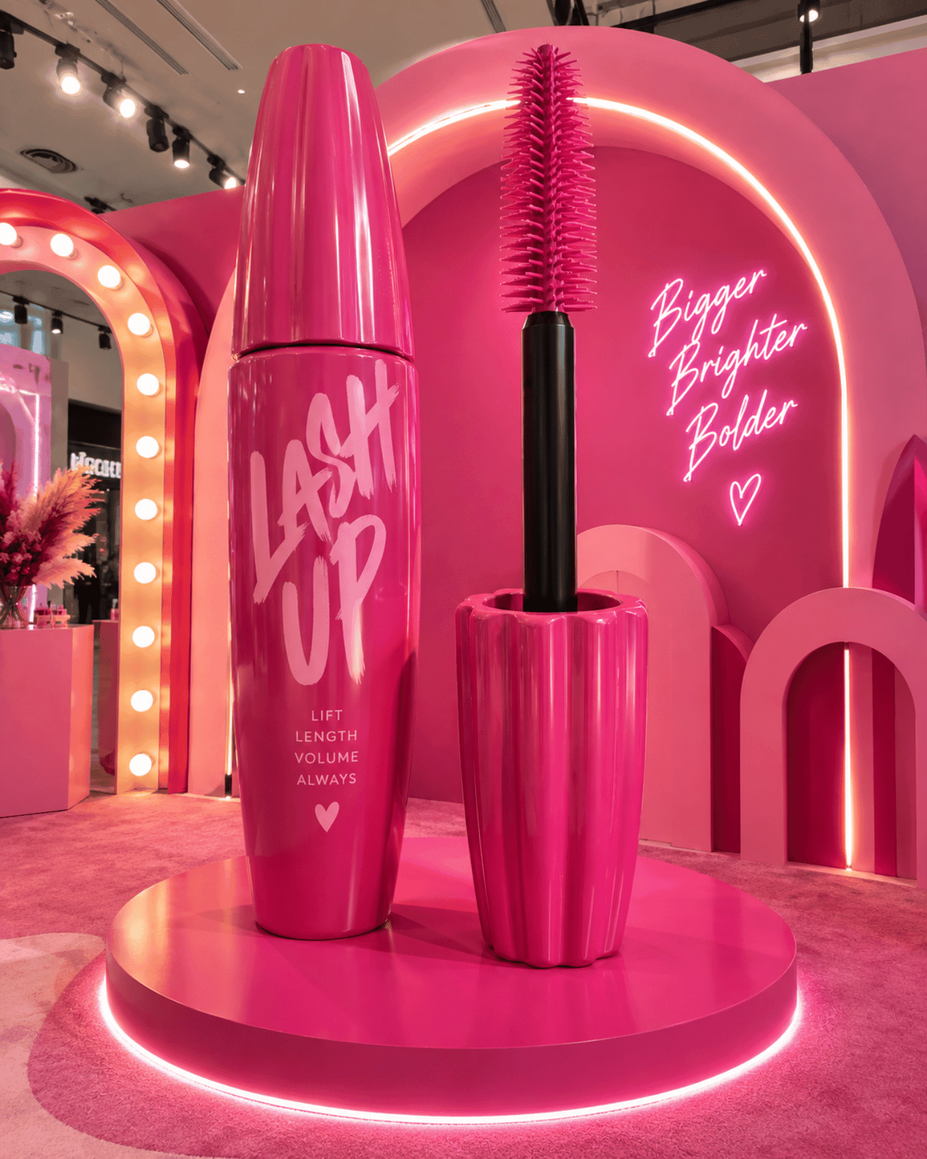 Oversized pink mascara tube and wand display