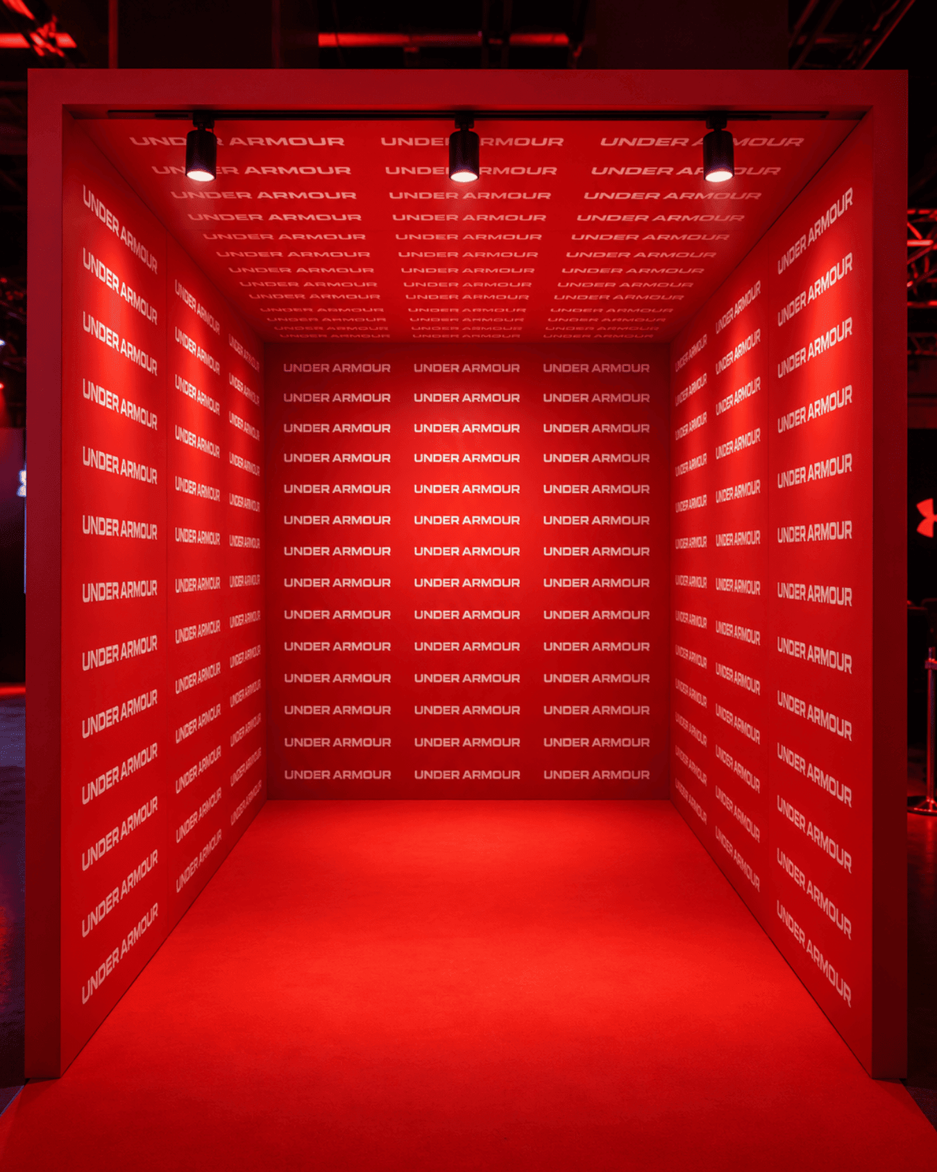 Red branded event corridor with illuminated rectangular frames